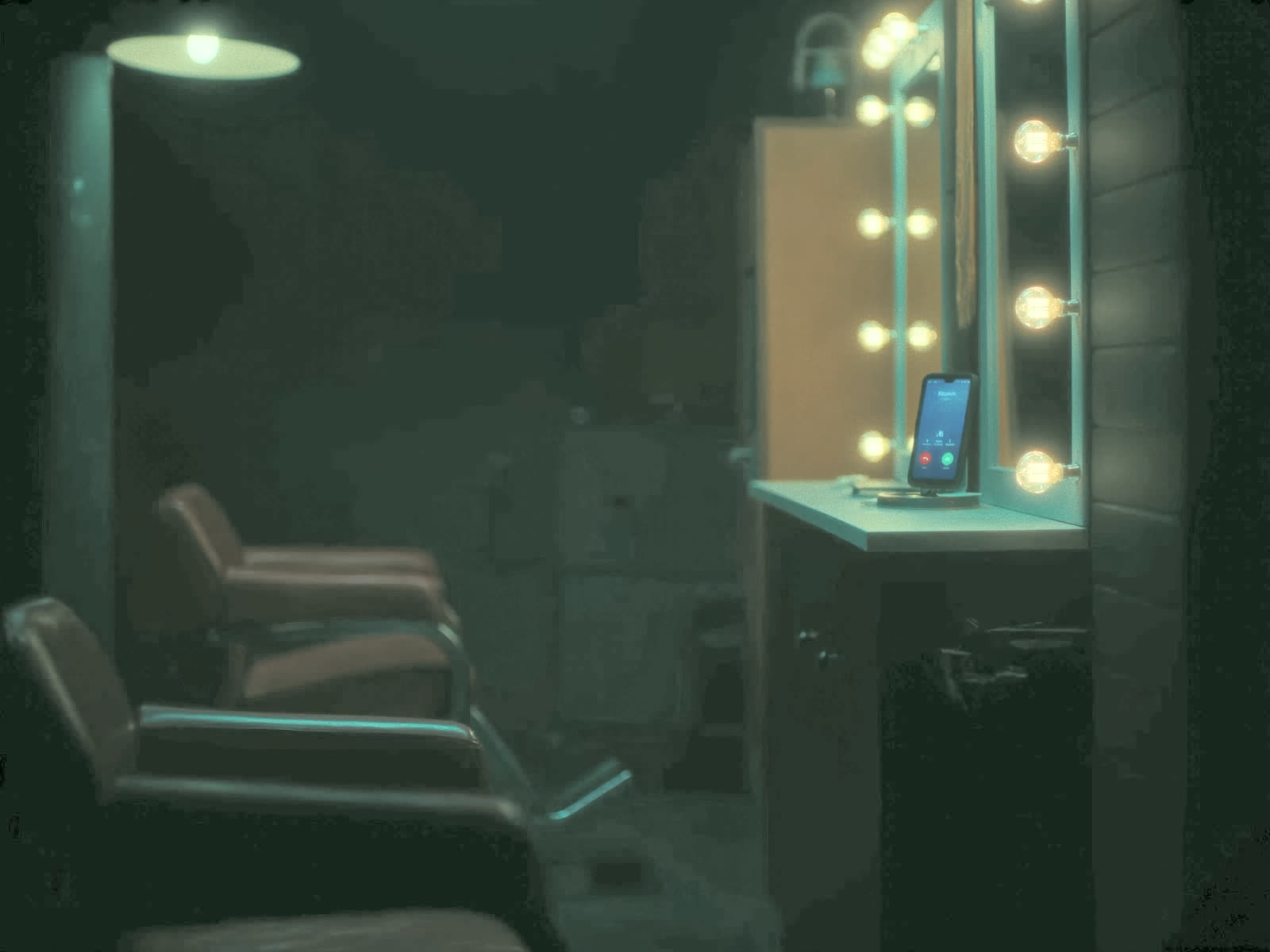 An empty styling chair in a dark salon at night while a phone glows with an incoming call at the counter.